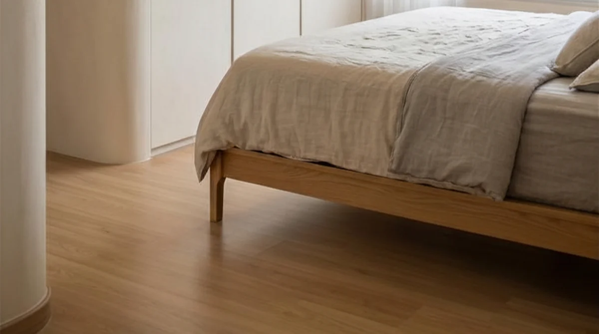 Pale wood-look vinyl plank flooring running to the skirting in an LN bedroom