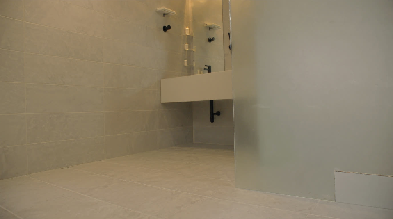 Light grey homogeneous porcelain floor and wall tiles in a modern Singapore HDB bathroom