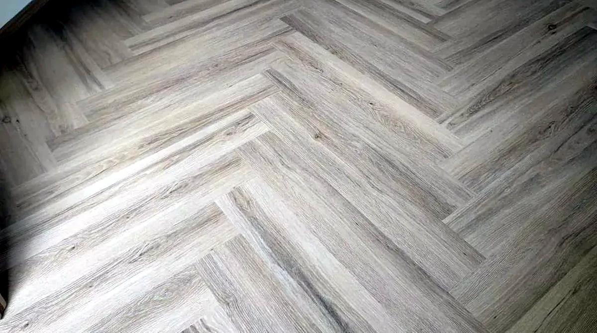 Herringbone LVT vinyl flooring in a Singapore home, the humidity-safe alternative to real parquet