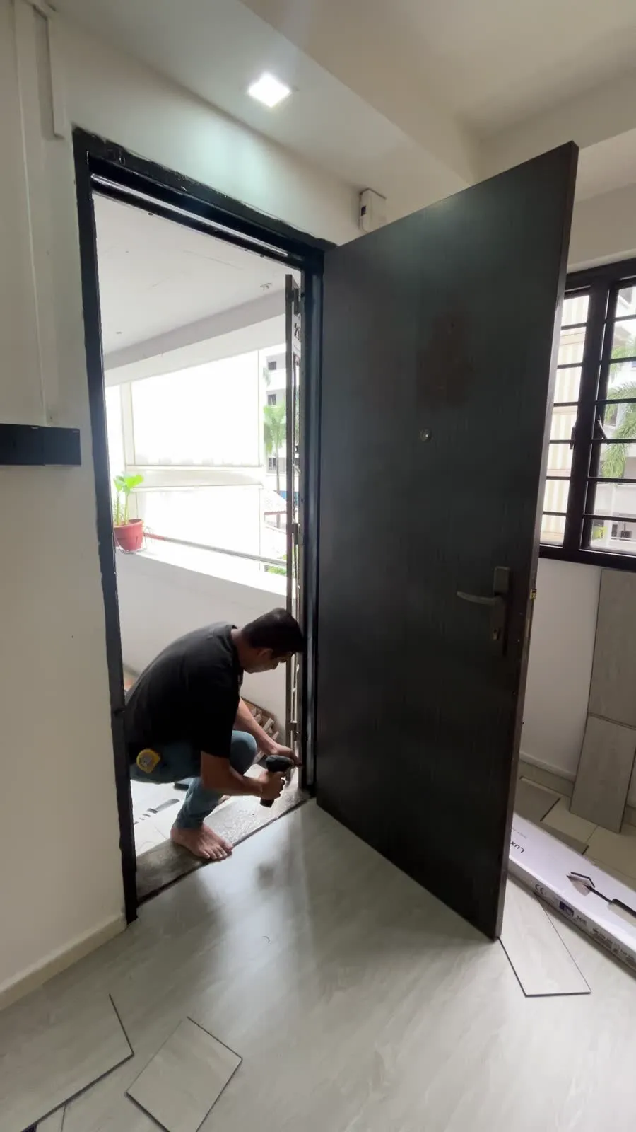 LN Flooring installer fitting vinyl overlay at an HDB flat in Yishun