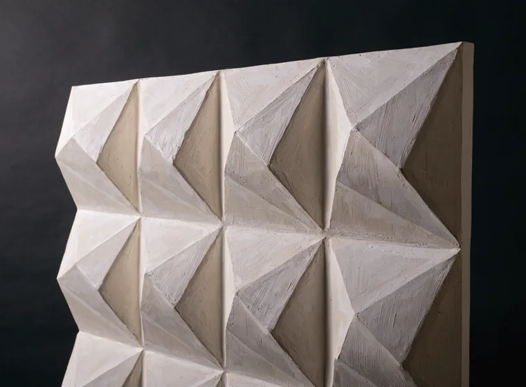 Macro close-up of a 3D decorative wall panel with a moulded geometric relief pattern