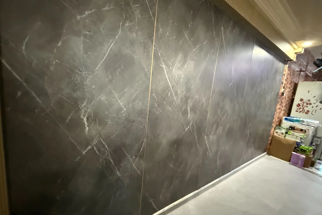 Grey marble-effect panelling on a bedroom feature wall
