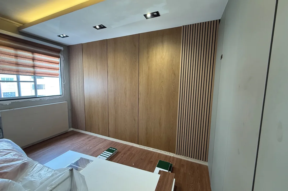 Walnut-effect panelling across a bedroom wall